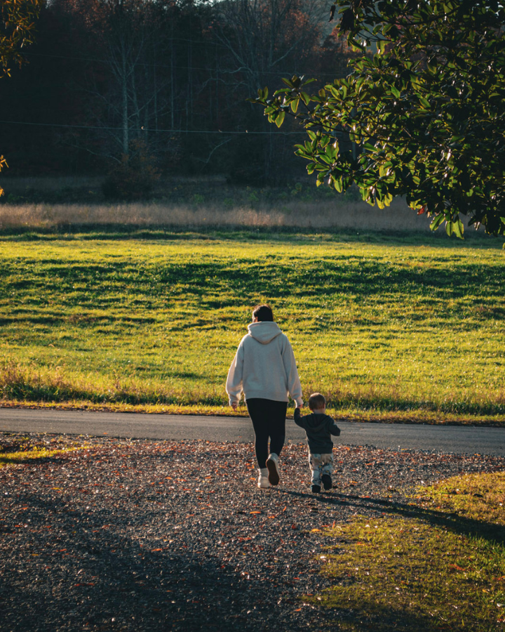 Mom and son holding hands walking