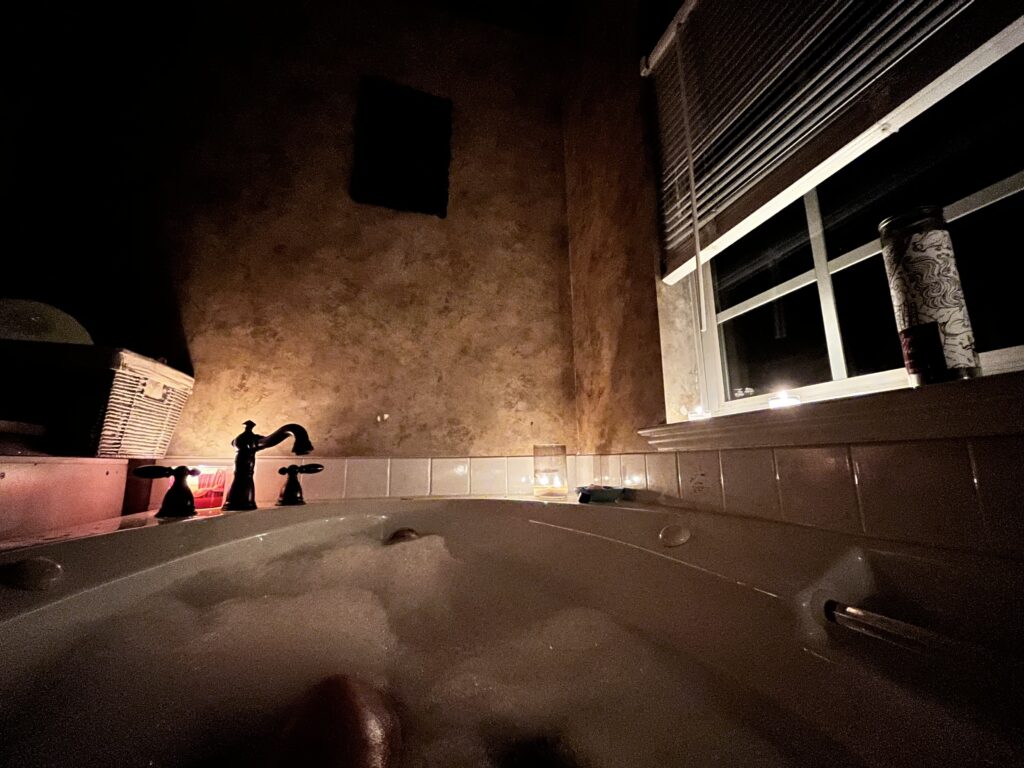 bathtub with bubbles and candle lights