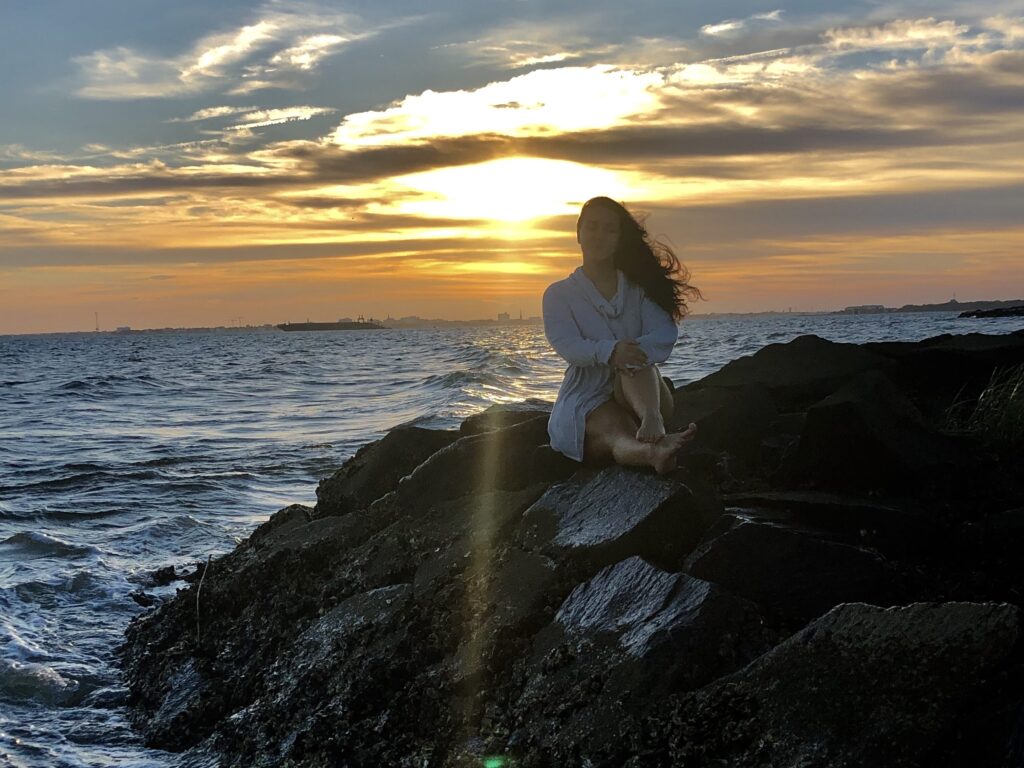 Beach at sunset sitting on rocks