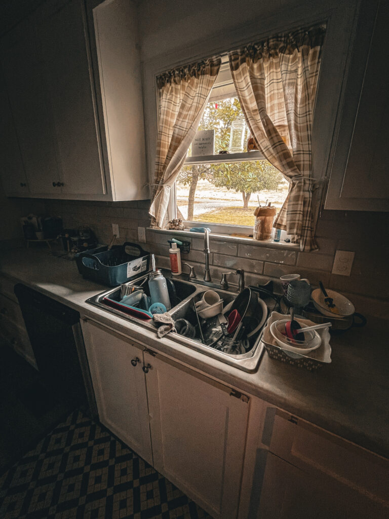 dirty dishes in the sink with morning light