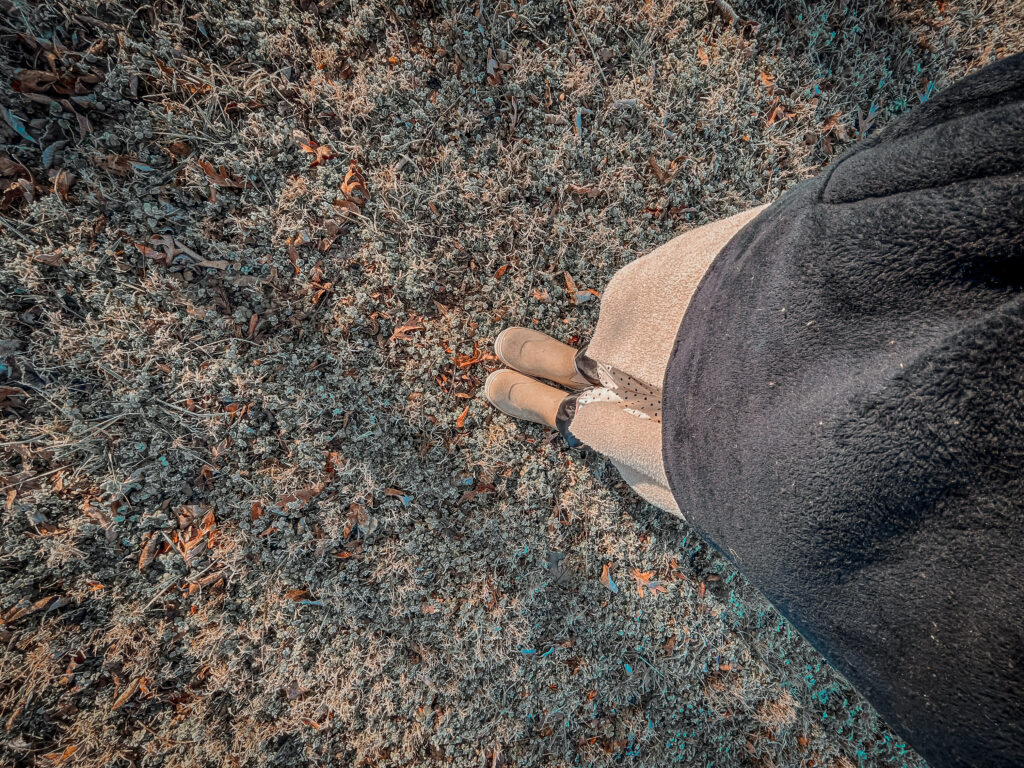 grounding with boots on in the winter grass