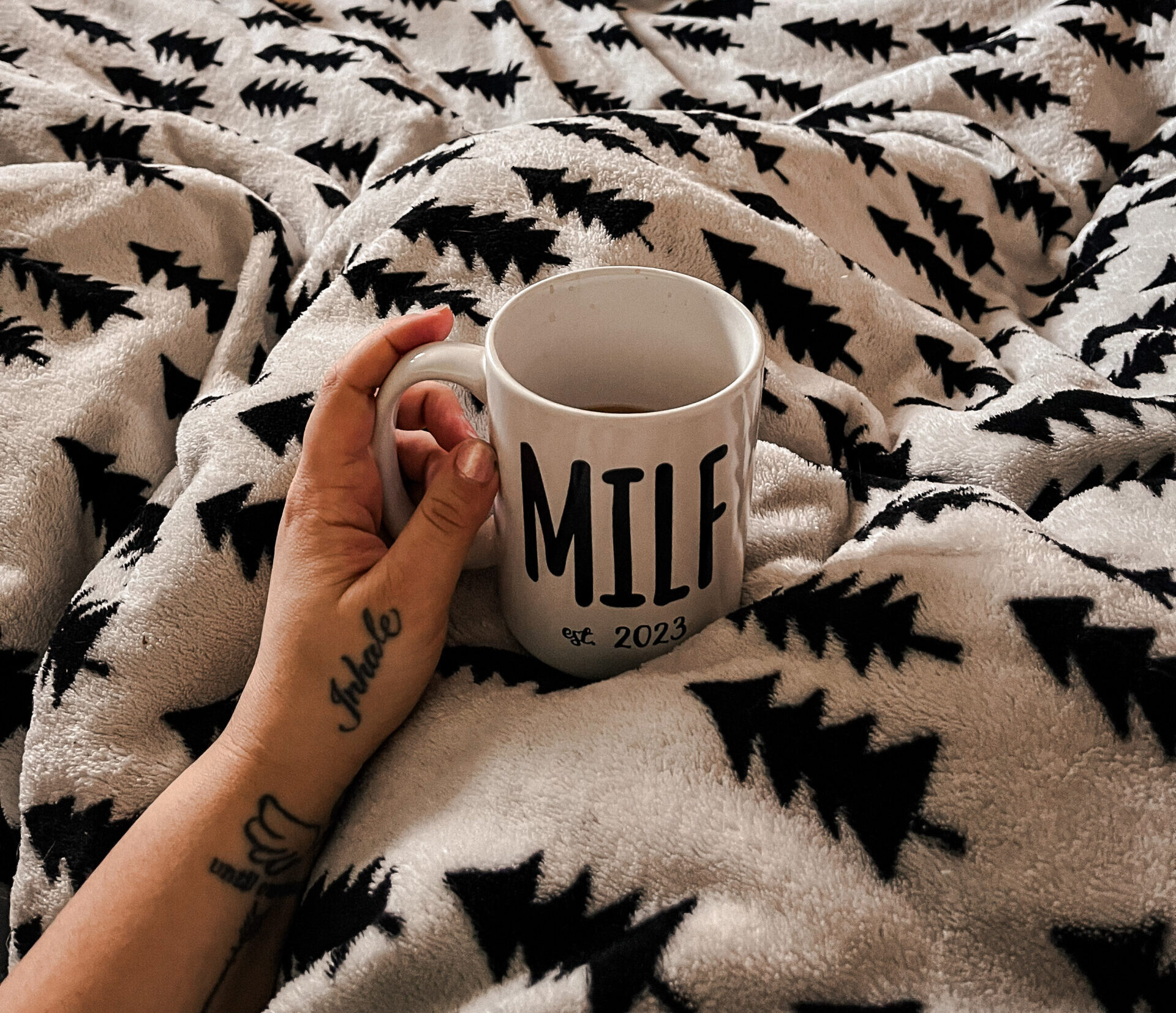 morning rest in bed for mom with coffee and train track in the background